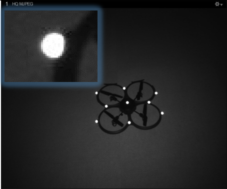 An image taken from an OptiTrack camera in MJPEG mode, with an inset close-up of a single marker. 